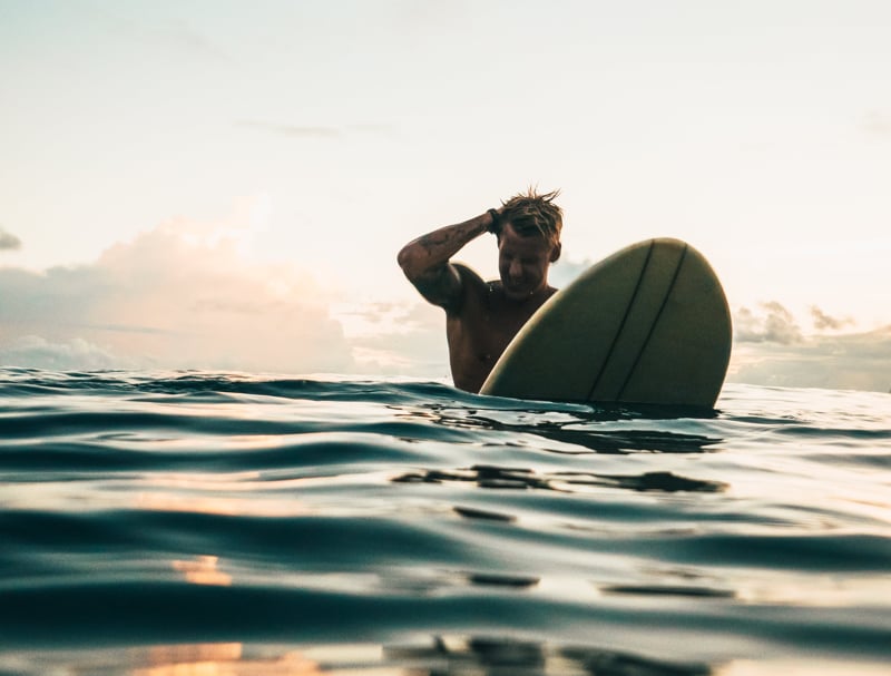 Surfer floating on his board | PointBreak