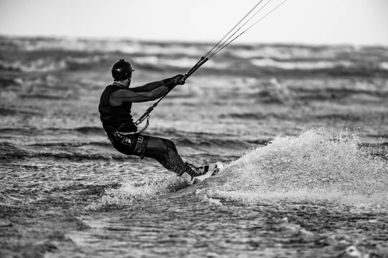 Uomo che va in kitesurf in bianco e nero | Point Break School
